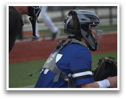 A baseball player wearing a blue shirt and white pants is squatting in the dirt. AI generated content