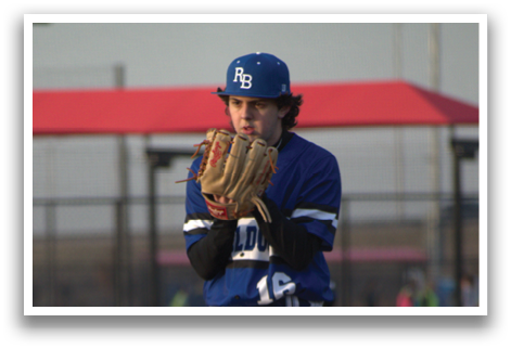 A baseball player in a blue and white uniform stands on the pitcher's mound, holding a baseball glove in his hand. AI generated content