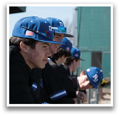 A group of young men wearing baseball caps and jerseys are sitting on a bench. AI generated content