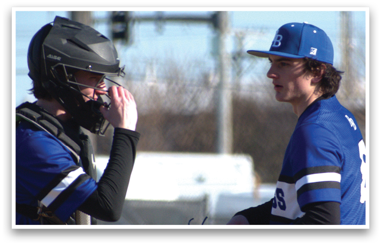 Two baseball players wearing blue and white uniforms are standing on a field. One player is holding a baseball glove and the other is wearing a helmet. AI generated content