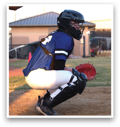A baseball player in a blue and black uniform squats on the field, wearing a helmet and holding a baseball glove. AI generated content