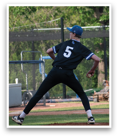A baseball player in a black shirt and blue cap is pitching a ball. Description generated by AI