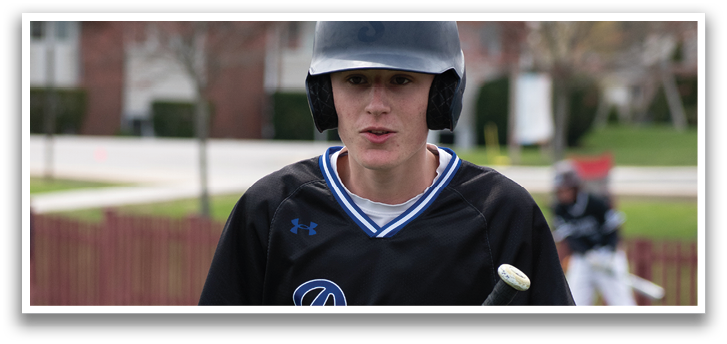 A man wearing a black shirt and holding a baseball bat. Description generated by AI