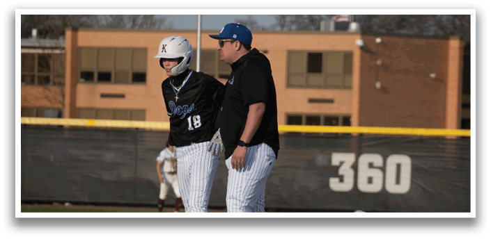 A baseball player is standing on a base. Description generated by AI