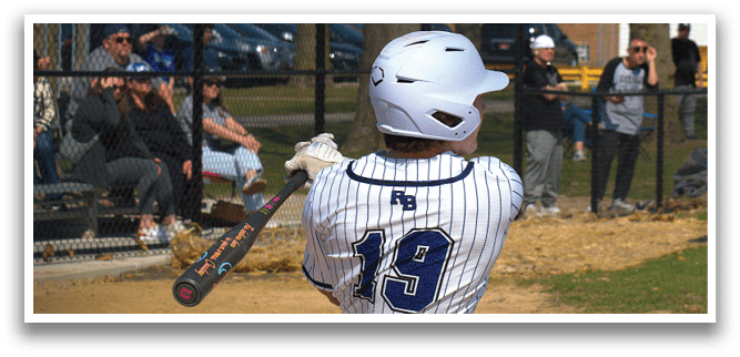 A baseball player in a white and blue uniform is swinging a bat. Description generated by AI