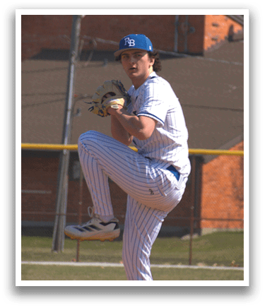 A baseball player in a blue and white uniform is on the pitcher's mound. Description generated by AI