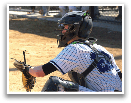 A baseball player wearing a helmet and catcher's gear. Description generated by AI