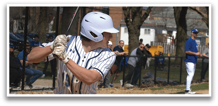 A baseball player in a blue and white uniform is swinging a bat. Description generated by AI