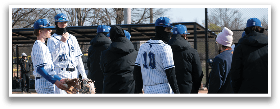 A group of baseball players standing on a field. Description generated by AI