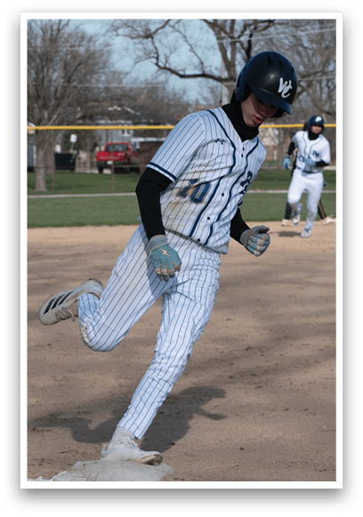 A baseball player running to a base. Description generated by AI