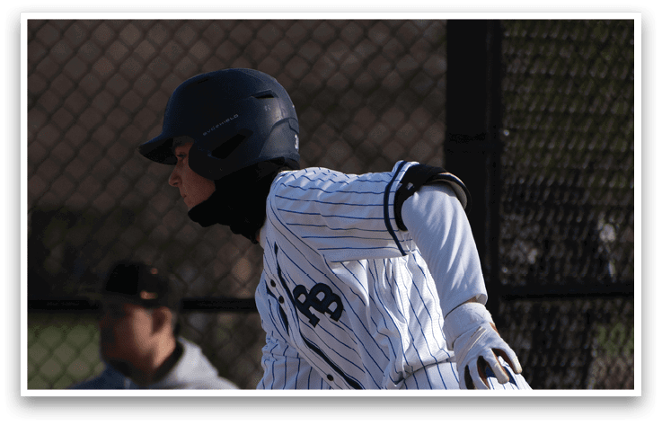 A baseball player in a white uniform is running. Description generated by AI