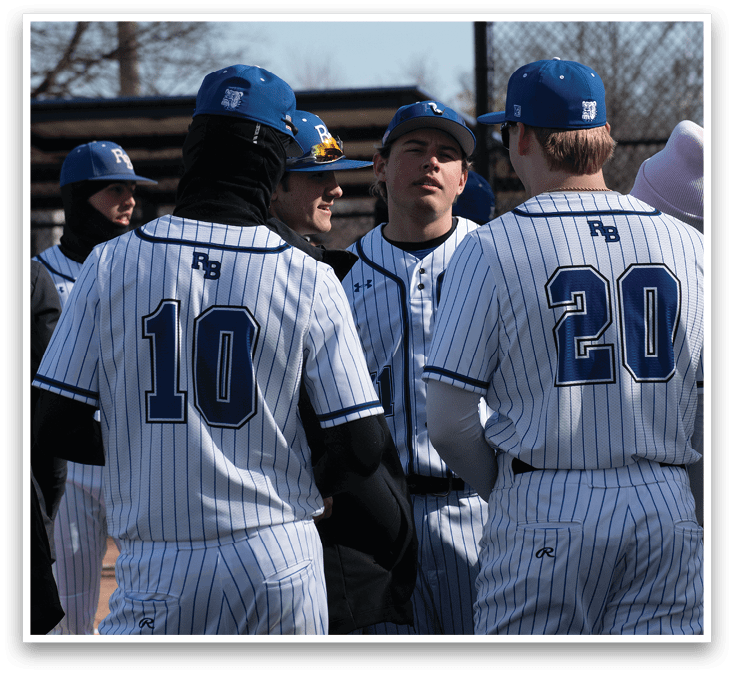 Baseball players wearing white and blue uniforms. Description generated by AI