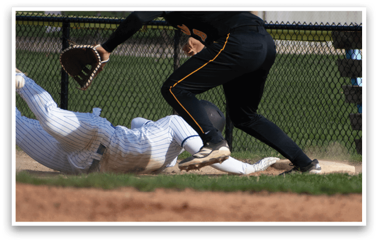 A baseball player sliding into a base. Description generated by AI