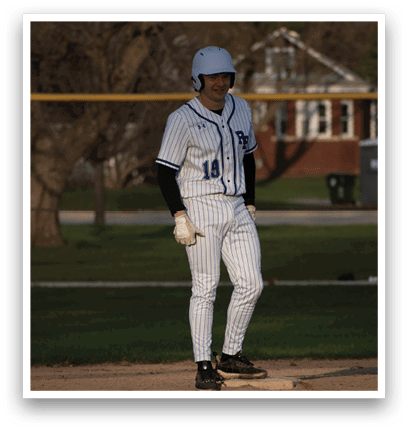 A baseball player wearing a white and blue uniform. Description generated by AI