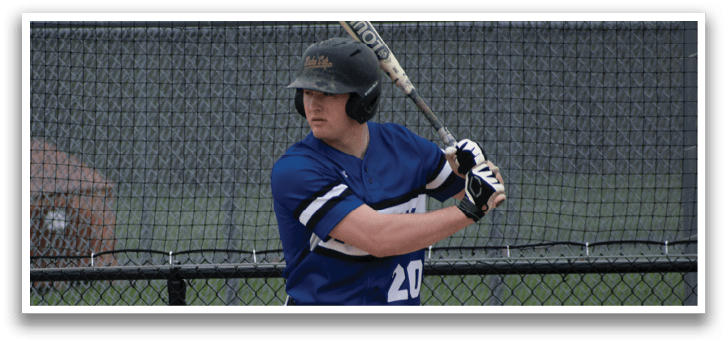 A baseball player in a blue and white uniform is swinging a bat. Description generated by AI