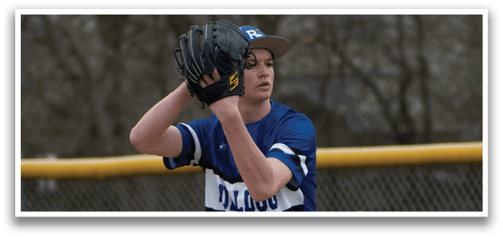 A baseball player in a blue and white uniform is pitching a ball. Description generated by AI