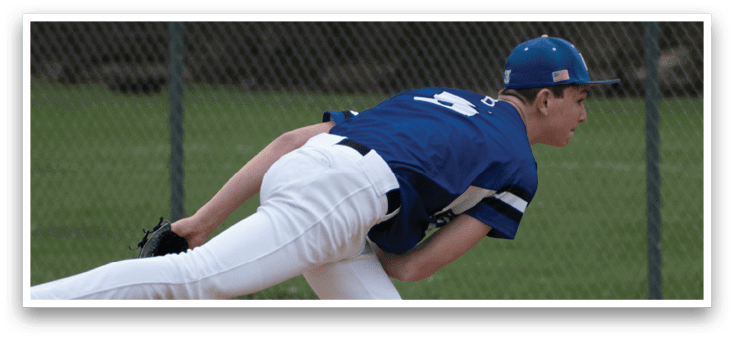 A baseball player in a blue shirt and white pants is pitching a ball. Description generated by AI