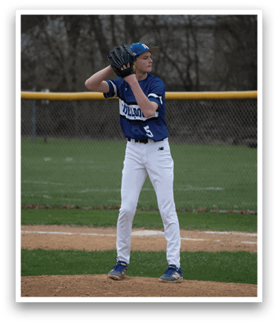 A baseball player wearing a blue and white uniform stands on the pitcher's mound. Description generated by AI