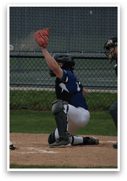 A baseball game is in progress with a batter swinging a bat and a catcher catching a ball. Description generated by AI