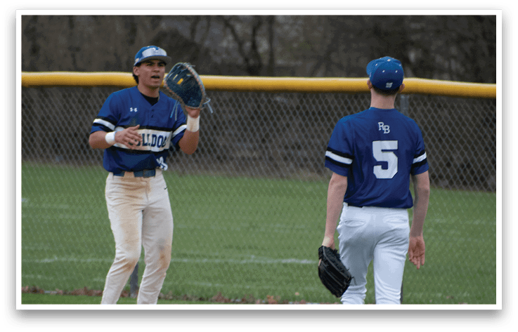 Two baseball players on a field. Description generated by AI