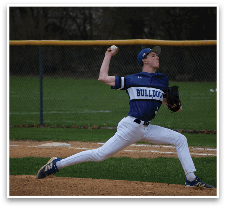 A baseball player in a blue and white uniform is pitching a ball. Description generated by AI
