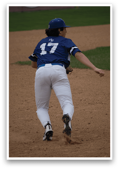 A baseball player wearing a blue and white uniform with the number 14 on the back. Description generated by AI
