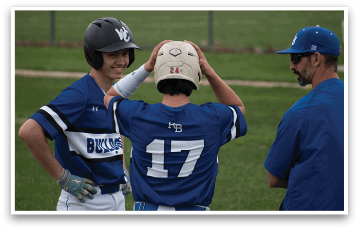 Two baseball players wearing blue and white uniforms. Description generated by AI