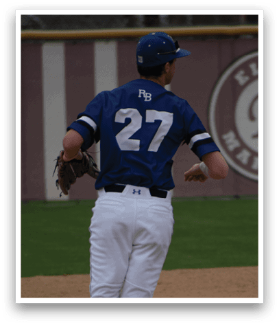 A baseball player wearing a blue and white uniform is running on the field. Description generated by AI