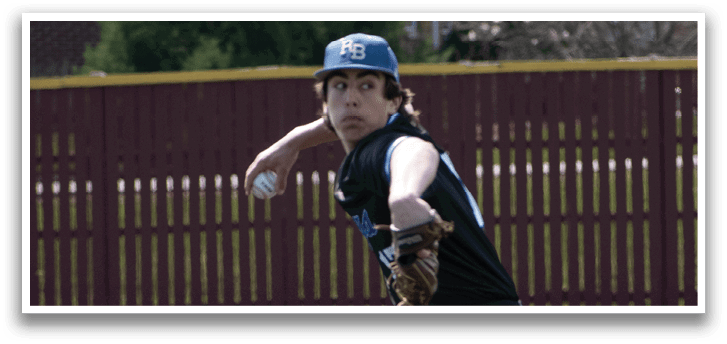 A baseball player in a black shirt and hat is pitching a ball. Description generated by AI