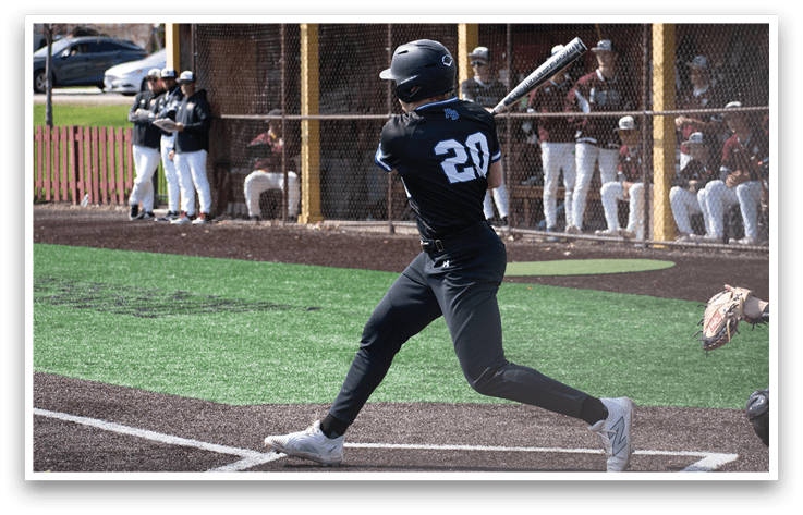 A baseball player in a black shirt and number 20 jersey is swinging a bat. Description generated by AI