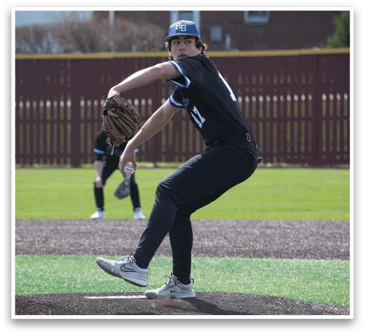 A baseball pitcher in a black shirt and hat is throwing a ball. Description generated by AI