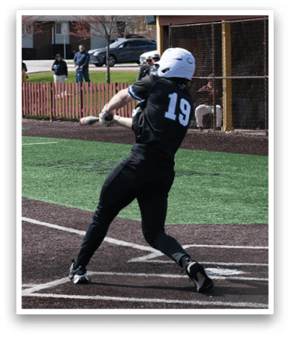 A baseball player in a black shirt and white helmet is swinging a bat. Description generated by AI