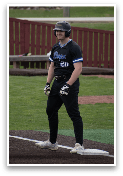 A baseball player wearing a black helmet and uniform. Description generated by AI