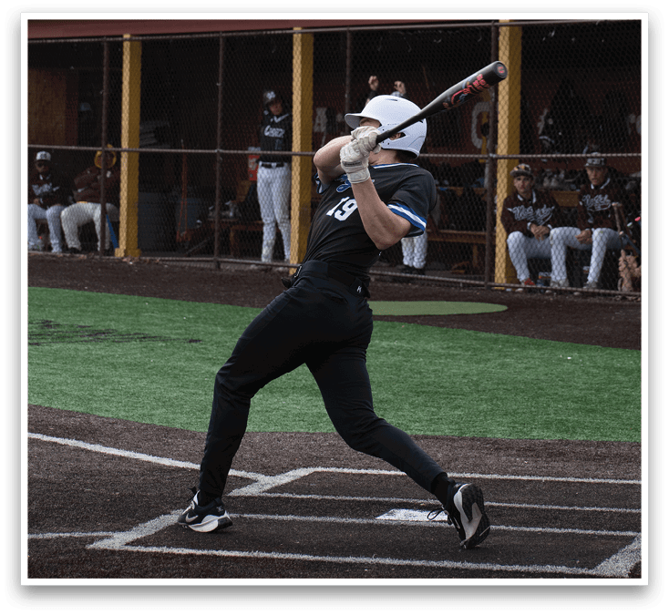 A baseball player is swinging a bat at a ball. Description generated by AI