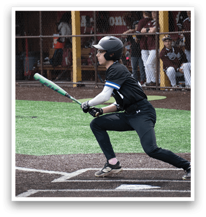 A baseball player is holding a bat and getting ready to hit the ball. Description generated by AI