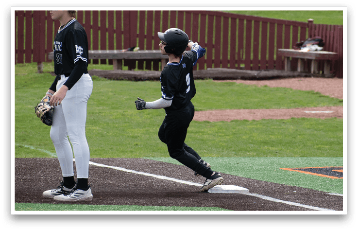 A boy in a black shirt and white pants is running towards a base. Description generated by AI