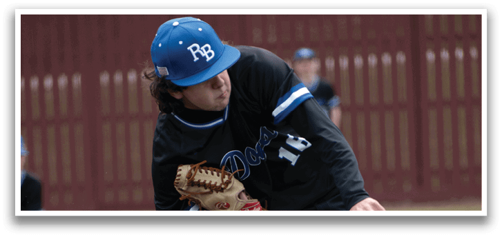 A baseball player in a black shirt and blue cap is pitching a ball. Description generated by AI