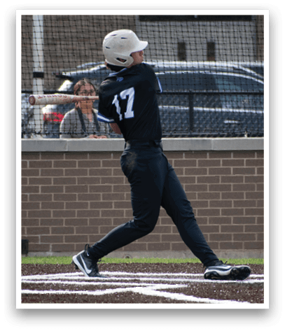 A baseball player wearing a black and white uniform is swinging a bat. Description generated by AI