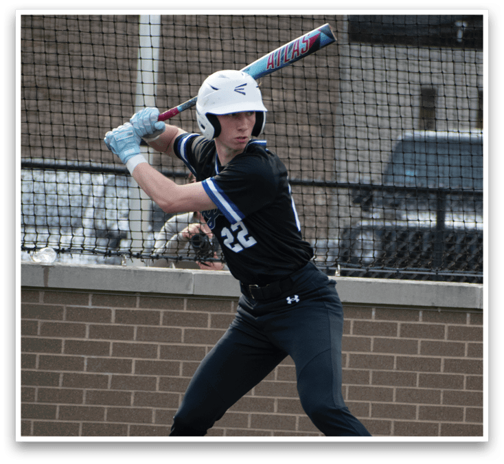 A baseball player in a black shirt and white helmet is swinging a bat. Description generated by AI