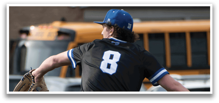 A baseball player in a black shirt and blue hat is throwing a ball. Description generated by AI