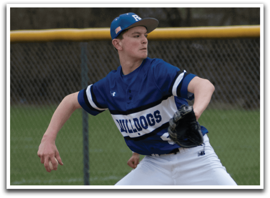 A baseball player in a blue and white uniform is pitching a ball. Description generated by AI