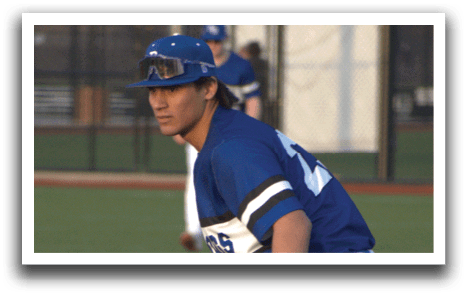 A baseball player wearing a blue shirt and white pants. Description generated by AI