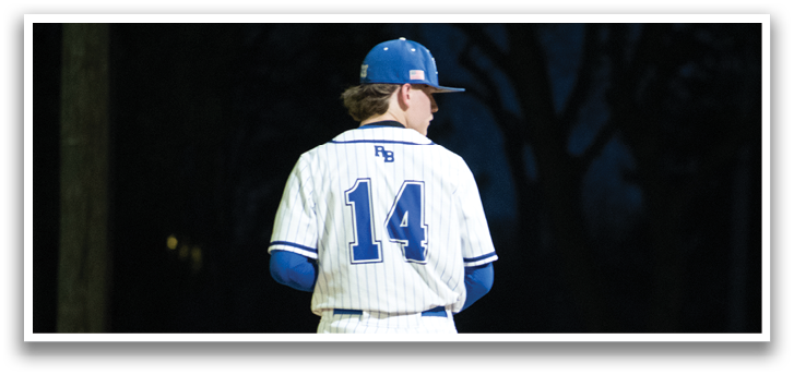 A baseball player wearing a blue and white uniform. Description generated by AI