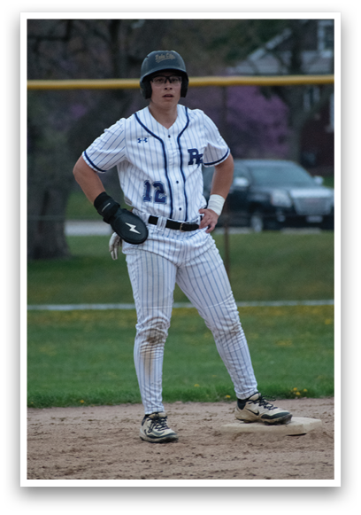 A baseball player wearing a blue and white uniform. Description generated by AI