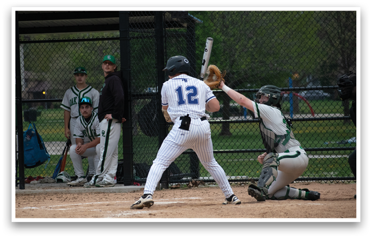 A baseball player is swinging a bat at a ball. Description generated by AI