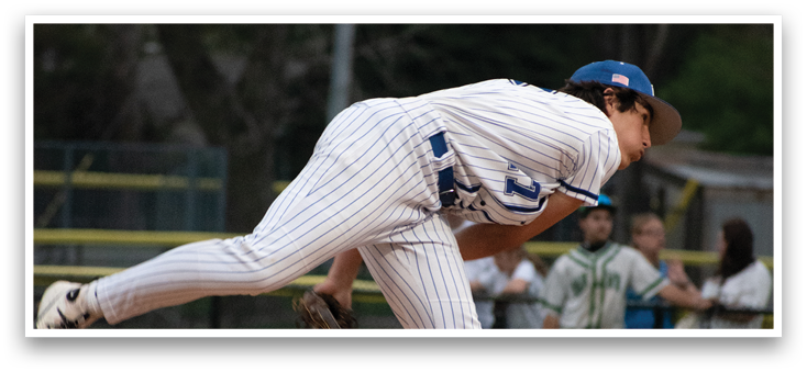 A baseball player in a white and blue uniform is throwing a ball. Description generated by AI