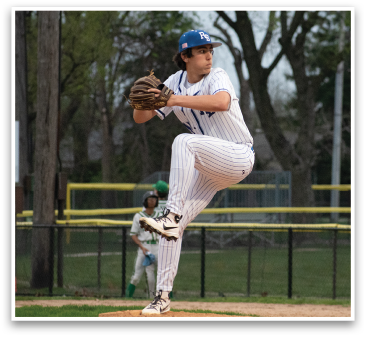A baseball player in a white uniform is pitching a ball. Description generated by AI