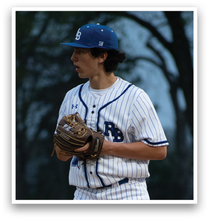 A baseball player wearing a blue and white uniform. Description generated by AI