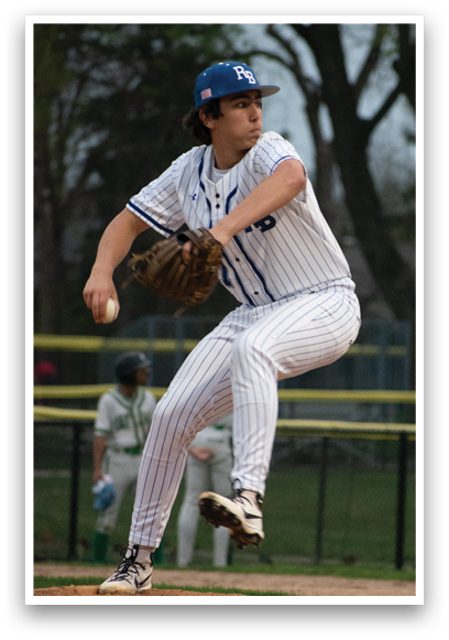 A baseball player in a blue and white uniform is pitching a ball. Description generated by AI