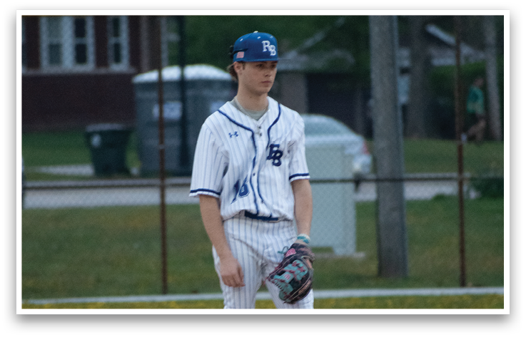 A baseball player standing on a field. Description generated by AI